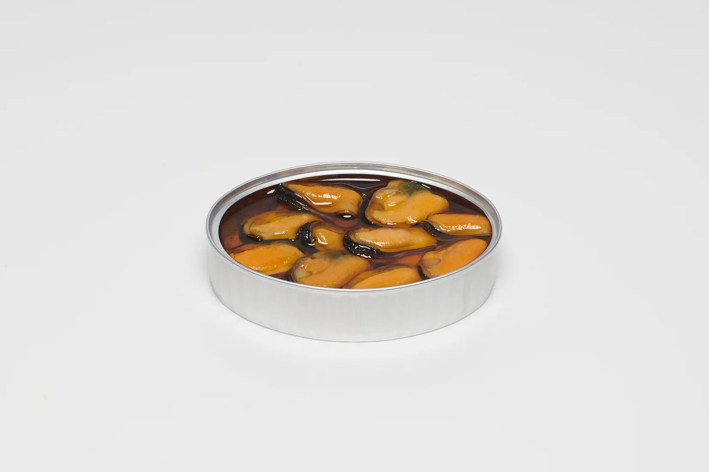 A close-up photo of an open, rectangular can of PYSCIS 3-Pack Blue Mussels with Garlic & Chili (SKU: MGP22). The can is made of metal and has a clear plastic lid that allows a view of the contents.